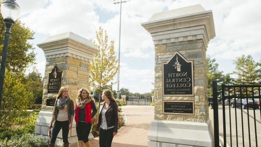 Students walking onto campus passed North Central College sign