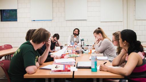 Students sitting around table in classroom