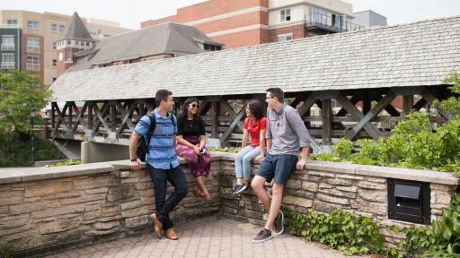 students hanging out at the naperville riverwalk