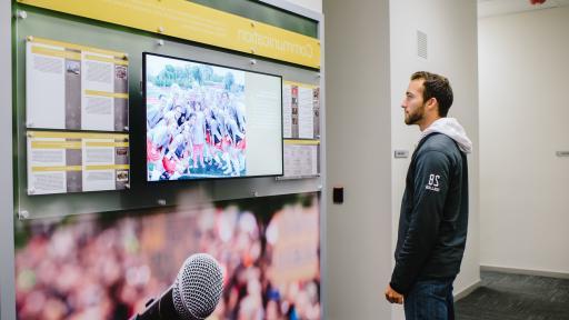 student looking at television in goldsphon hall 