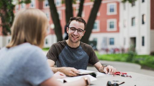 Students outside at a table